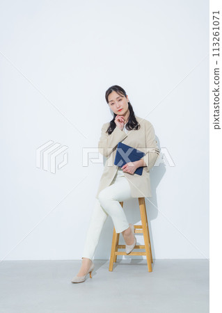 Smiling businesswoman holding a tablet 113261071