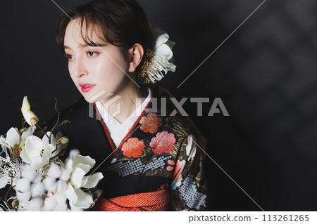 A woman in a black long-sleeved kimono A woman in a black long-sleeved kimono 113261265