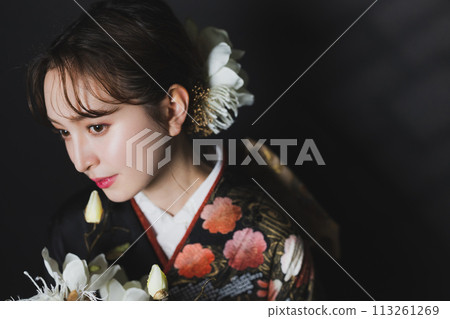 A woman in a black long-sleeved kimono A woman in a black long-sleeved kimono 113261269