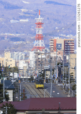 [Vertical composition, logo, driver blurred] Tram arriving and departing from Hakodate City Tram Aoyagicho Station 113261276