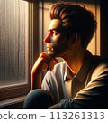 A young man thinking by the window 113261313