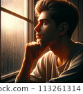 A young man thinking by the window 113261314