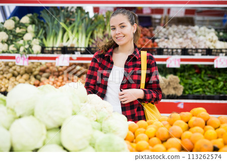 Positive customer chooses cabbages at grocery store Positive customer chooses cabbages at grocery store 113262574