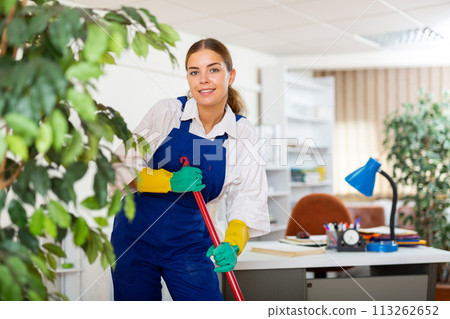 Woman cleaning office with mop Woman cleaning office with mop 113262652