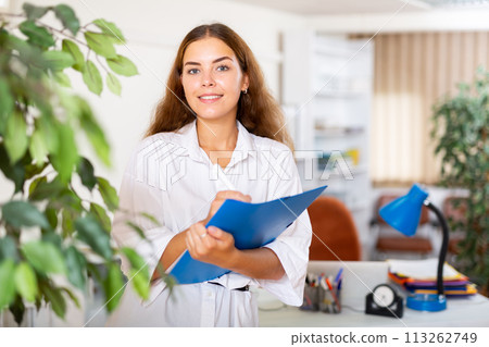 Confident young secretary takes important notes on a tablet in a office Confident young secretary takes important notes on a tablet in a office 113262749