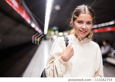 Beautiful young woman in blue jeans standing on metro station Beautiful young woman in blue jeans standing on metro station 113262754