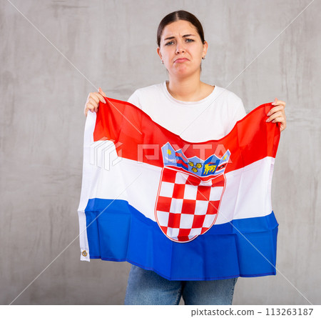 Portrait of an upset girl holding Croatian flag in her hands Portrait of an upset girl holding Croatian flag in her hands 113263187