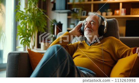 Senior Man Enjoying Music in Cozy Living Room Senior Man Enjoying Music in Cozy Living Room 113263998