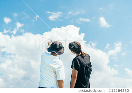 一對30多歲的夫婦凝視夏日雲彩的後視圖 113264280