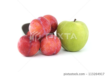 Red plums and green apple isolated on white background Red plums and green apple isolated on white background 113264917