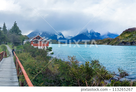 Red House by the Turquoise Lake in Mountainous Landscape 113265267