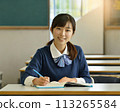 A female student studying with a smile in the classroom 113265584