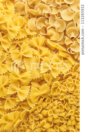 Uncooked Italian different pasta types background, top view. High quality photo. 113265932