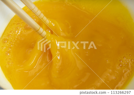 Tamagoyaki process: Mixing the eggs 113266297