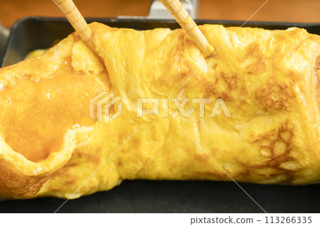 Tamagoyaki process: pouring in the eggs Tamagoyaki process: pouring in the eggs 113266335
