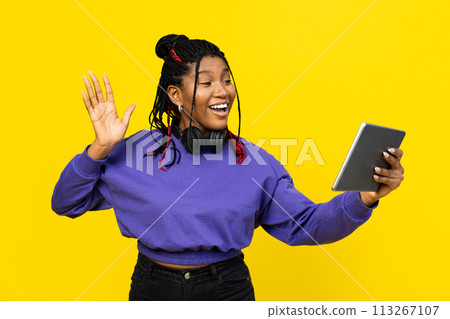Woman Waving Hello During Video Call On Her Tablet Woman Waving Hello During Video Call On Her Tablet 113267107