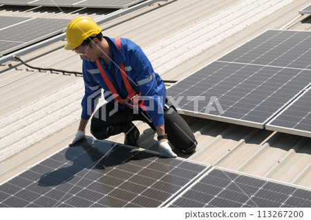 Engineers install solar cells on the roof of factory 113267200