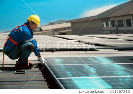 Engineers install solar cells on the roof of factory 113267210