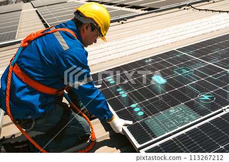 Engineers install solar cells on the roof of factory 113267212