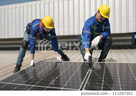 Engineers install solar cells on the roof of factory Engineers install solar cells on the roof of factory 113267301