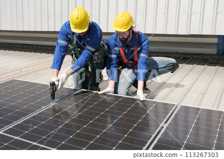 Engineers install solar cells on the roof of factory Engineers install solar cells on the roof of factory 113267303