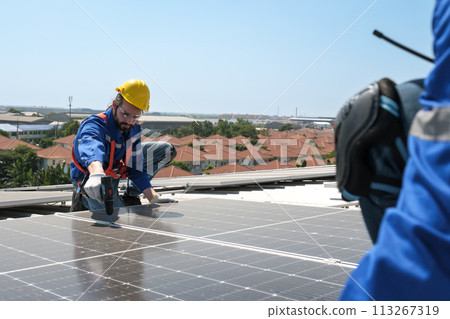 Engineers install solar cells on the roof of factory Engineers install solar cells on the roof of factory 113267319
