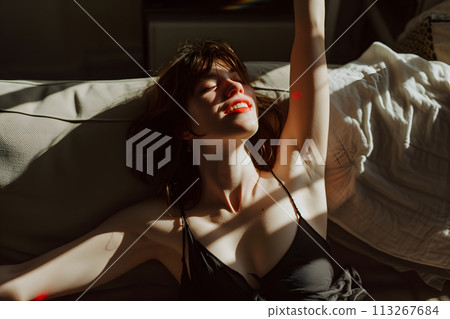 Intimate Melodies: Captivating Young Woman in Lingerie Dancing at Home 113267684