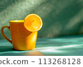 Sip of Sunshine: Fresh Orange Juice and Lemon Slice on Green Backdrop 113268128
