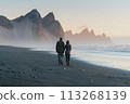 Mountain Magic: Traveling Couple Revels in Breathtaking Views from Iceland's Black Beach 113268139