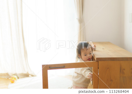 Baby playing with furniture doors opening and closing Baby playing with furniture doors opening and closing 113268404