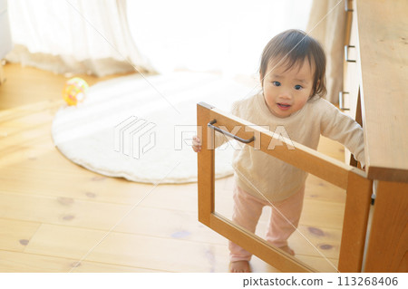 Baby playing with furniture doors opening and closing Baby playing with furniture doors opening and closing 113268406