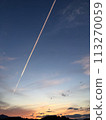 Contrail dyed at sunset 113270059