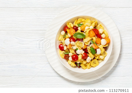 tortellini salad with tomatoes, mozzarella in bowl tortellini salad with tomatoes, mozzarella in bowl 113270911
