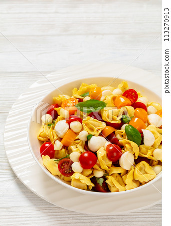 tortellini salad with tomatoes, mozzarella in bowl tortellini salad with tomatoes, mozzarella in bowl 113270913