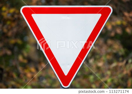 Give way road sign over blurred background Give way road sign over blurred background 113271174