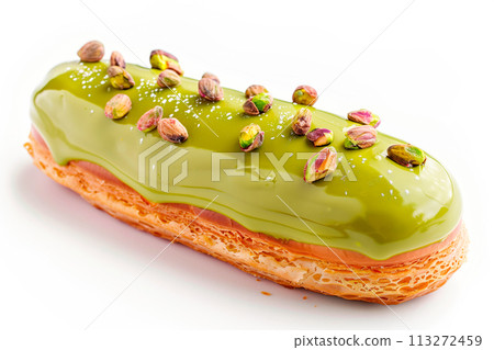 Delicious pistachios eclair topped with nuts on a white background 113272459