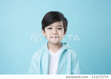 A young boy is wearing a blue hoodie and smiling 113272754