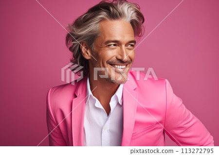 A man in a pink suit is smiling and looking at the camera 113272795