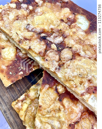 Pieces of cheese pizza with a baked ruddy crust 113274786
