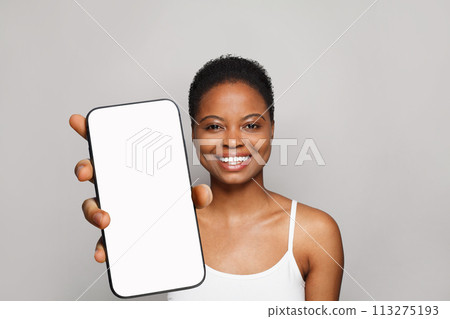 Joyful healthy woman holding smartphone with white empty blank screen display Joyful healthy woman holding smartphone with white empty blank screen display 113275193