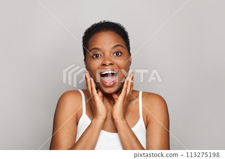 Surprised healthy lady with dark clean fresh skin on white background.  113275198