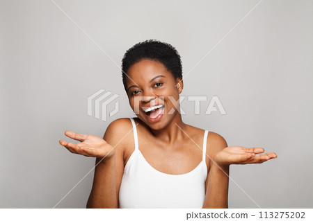 Laughing healthy lady with dark clean fresh skin on white background. Advertising, product placement Laughing healthy lady with dark clean fresh skin on white background. Advertising, product placement 113275202