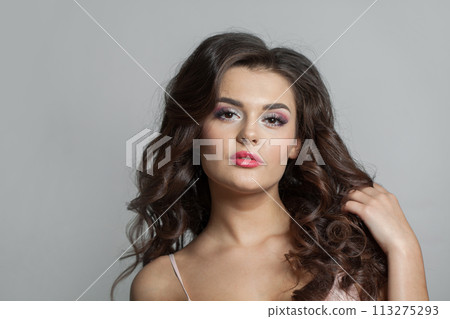 Perfect fashion model with perfect clear skin, long curly hairstyle and make-up on white background. 113275293