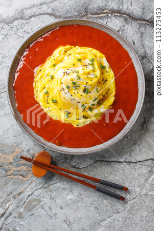 Tornado Omelette Omurice with Sriracha Ketchup closeup on the plate. Vertical top view 113275453