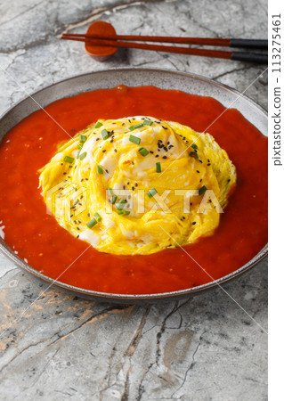 Korean tornado rice omelette and hot sauce closeup on the plate. Vertical 113275461
