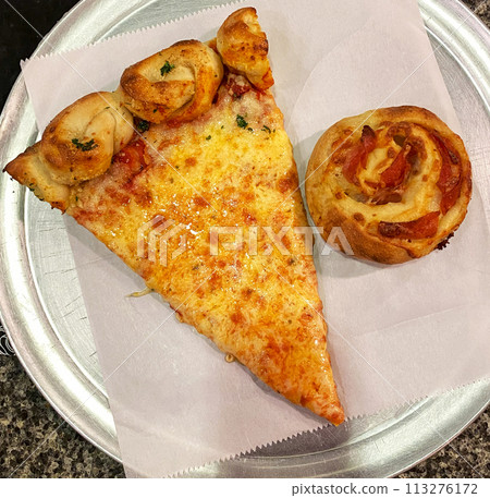 Slice of Pizza and Pastry on Plate with garlic knot crust Slice of Pizza and Pastry on Plate with garlic knot crust 113276172