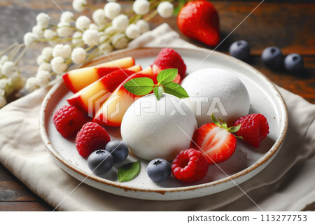 Traditional Japanese dessert White Mochi ice cream with fresh berries and mint leaves on a beautiful plate 113277753