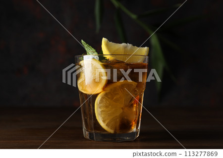 A glass of cold tea on a dark background 113277869