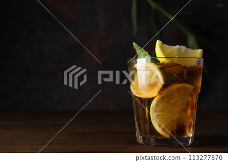 A glass of cold tea on a dark background A glass of cold tea on a dark background 113277870