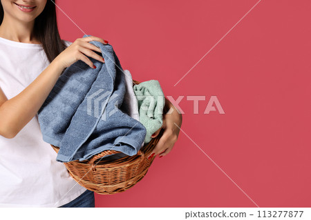 A girl, a housewife, with a basket of laundry. A girl, a housewife, with a basket of laundry. 113277877
